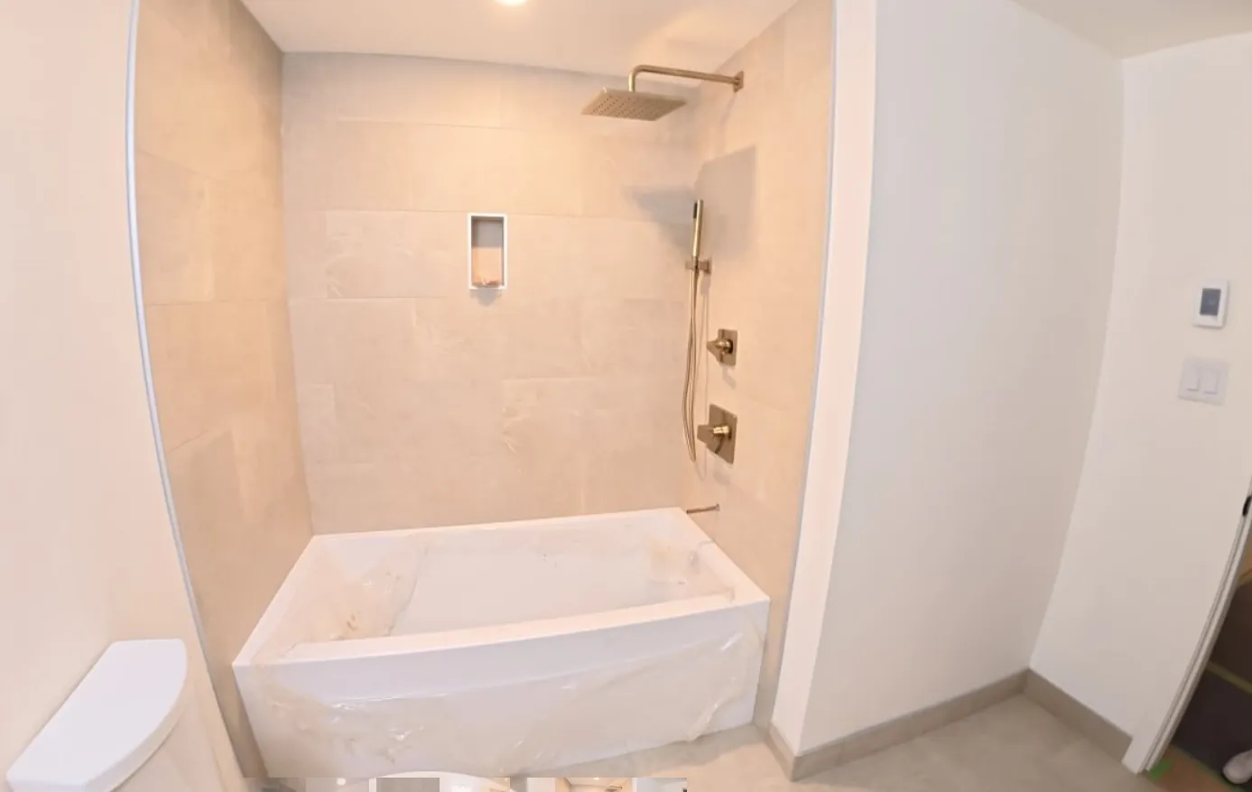 Custom marble walk-in shower with seamless glass enclosure — Victoria, BC bathroom renovation by NovoTile