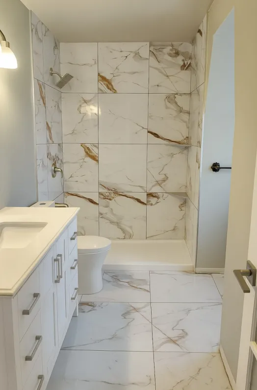 Heated tile floor with mitred edge stone vanity — primary bath renovation by NovoTile