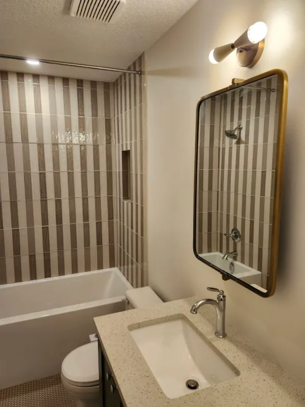 Powder room with slab-matched marble wall and floating stone vanity — BC renovation