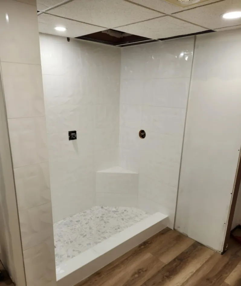 Large-format porcelain shower wall with linear drain — luxury wet room in British Columbia