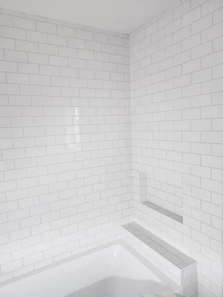 Classic white subway tile shower with mitred edges installed by NovoTile in Victoria, BC